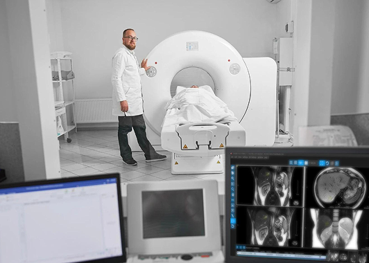 Radiologist by MRI machine with patient, images on screens