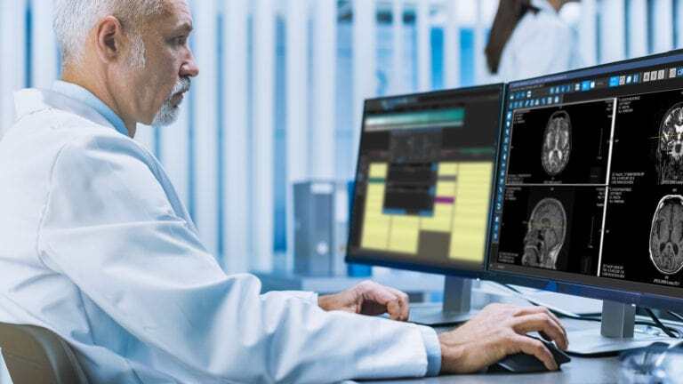 A male doctor is using RIS and PACS