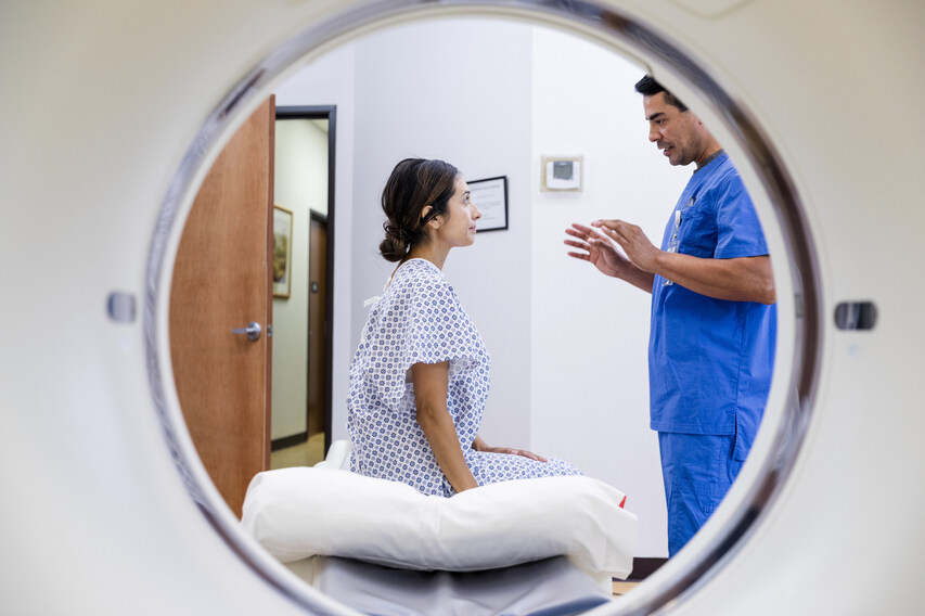Patient consults with doctor before MRI scan supported by radiology information system (RIS).