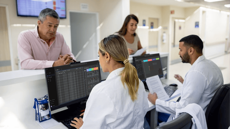 Radiology staff managing patient check-in and imaging workflows at a front desk
